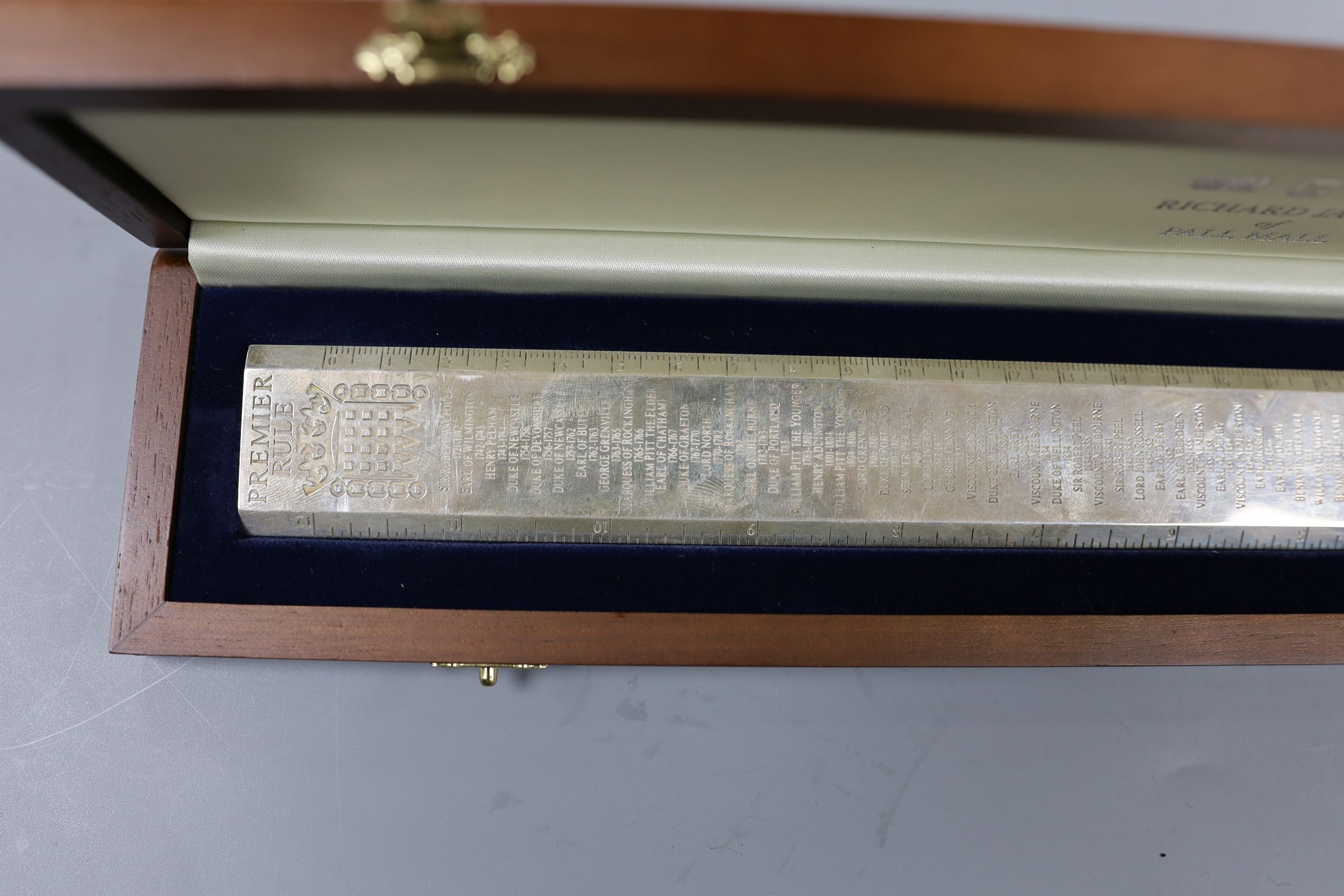 A cased modern silver 'Premier Rule' ruler, engraved with the names and dates of British Prime ministers, by Richard Jarvis, London, 2003, 10oz.